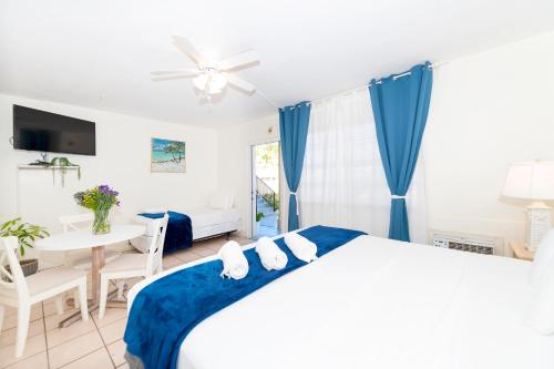 a bedroom with a bed and a dining room with a table at Tropic Isle Hotel & Apartment in Hollywood