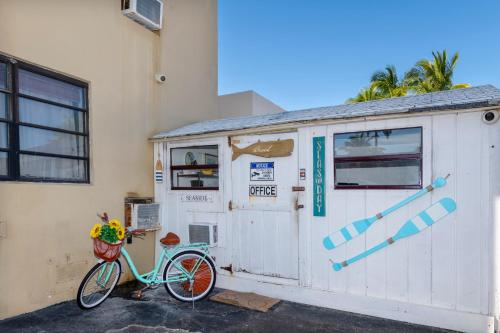 a bike parked next to a building with a door at Tropic Isle Hotel & Apartment in Hollywood