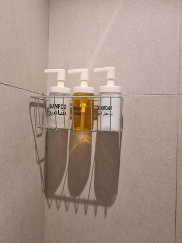 a group of four medicine bottles hanging on a wall at Luxury sea view Apartment In Address Hotel Fujairah in Fujairah