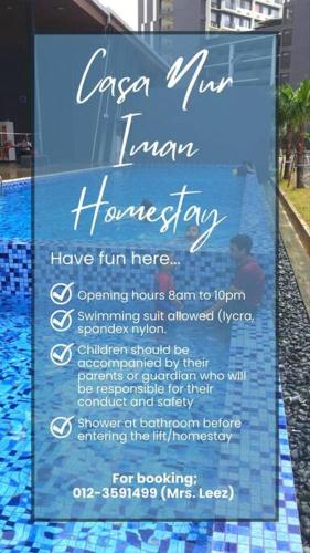 a sign that is next to a swimming pool at Homestay Casa Nur Iman @Adelia in Kajang