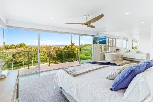 a bedroom with a large bed and a large window at Saltwater, Sunrise Beach in Sunrise Beach