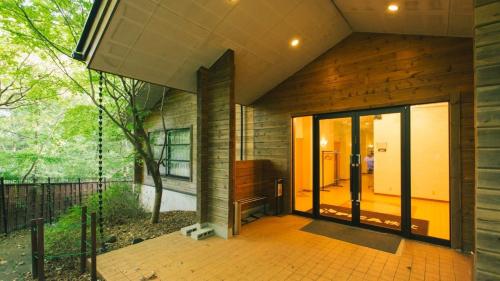 a house with a large glass door on a porch at PICA Chichibu in Chichibu