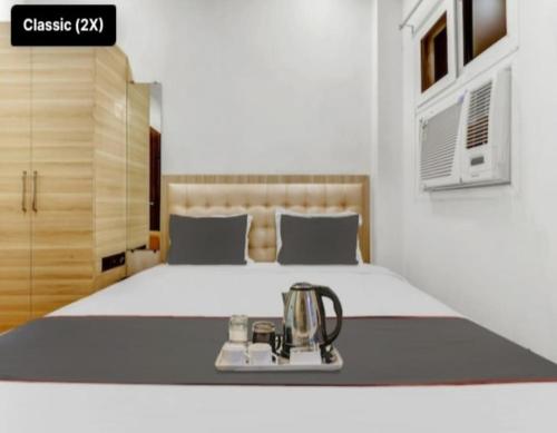a bedroom with a bed with a juicer on it at Shri Tirupati Residency in Nilmatha