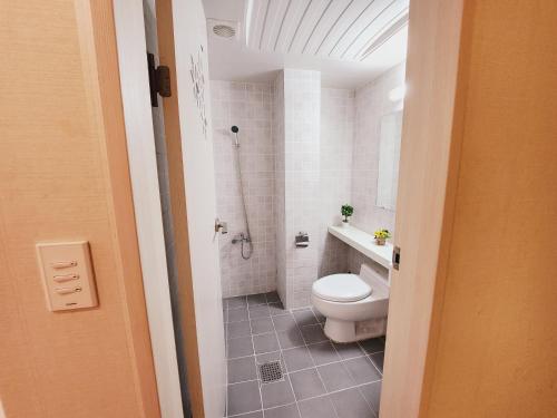 a bathroom with a toilet and a sink and a shower at Olive hostel R(Residence) in Seoul