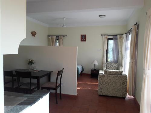 een woonkamer met een tafel en een stoel bij Drala Resort Nepal in Kathmandu