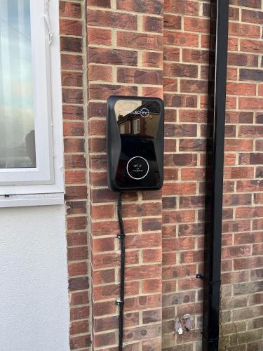 a pay phone is attached to a brick wall at Numero Uno Detached Aparthouse in Newcastle upon Tyne