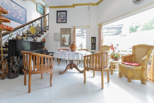 sala de estar con mesa y sillas en RedDoorz at Villa Puncak Tidar, en Malang