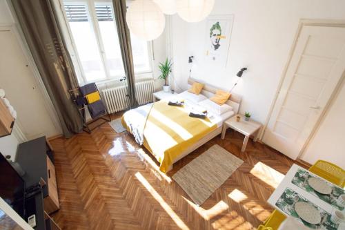 a bedroom with a large bed in a room at Pavla Papa Studio - Bright & central in Novi Sad