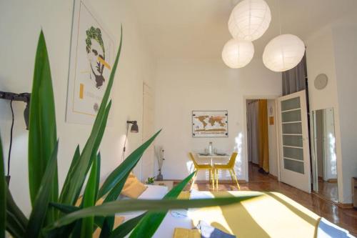 a living room with a table and a chair at Pavla Papa Studio - Bright & central in Novi Sad