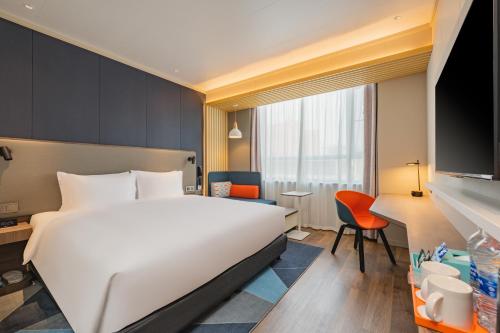 a hotel room with a bed and a desk at Holiday Inn Express Taiyuan High Tech Zone by IHG in Taiyuan