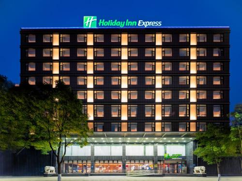 a lit up building with a hotel sign on it at Holiday Inn Express Taiyuan High Tech Zone by IHG in Taiyuan