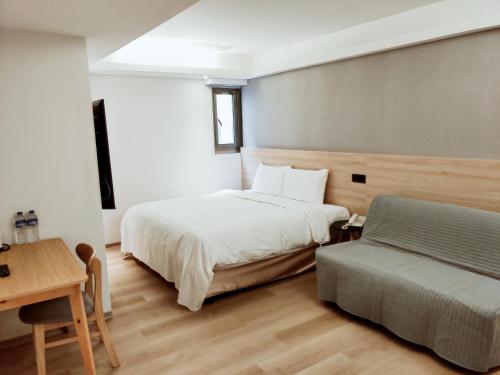 Voodi või voodid majutusasutuse Fooyee Hotel - Yonghe toas