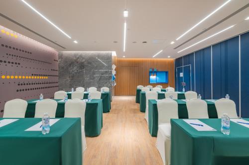 a conference room with green tables and white chairs at Holiday Inn Express Taiyuan High Tech Zone by IHG in Taiyuan