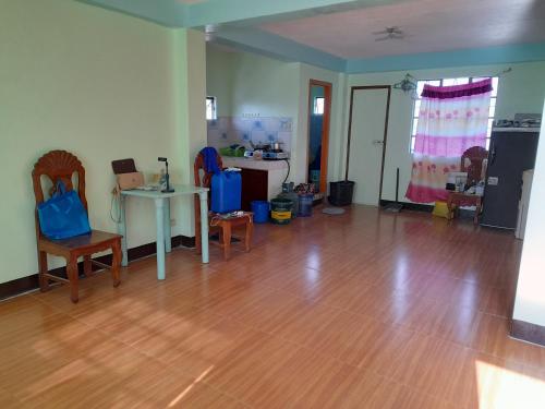 a living room with a wooden floor and a table at MJ TRANSIENT 5 in Baguio