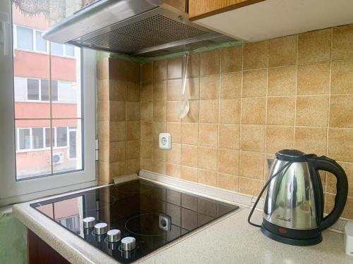 a kitchen with a tea kettle on a counter at Korca Central Flat in Korçë