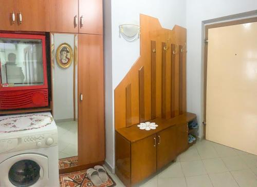a kitchen with a refrigerator and a washing machine at Korca Central Flat in Korçë