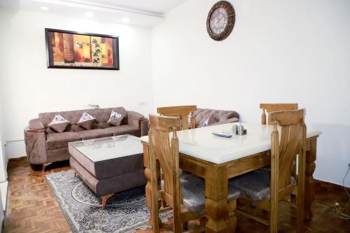 a living room with a table and a couch at Fortune Home Service Apartment 3Bhk,E-28 Saket 1B in New Delhi