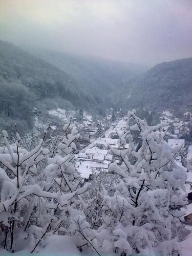 a snow covered valley with a town in the distance at Hámori Álom in Miskolc