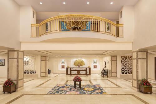 a large lobby with a staircase and a table at Fortune Park Kufri, Shimla - Member ITC Hotels' Group in Shimla