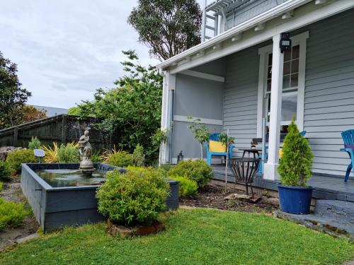 a front yard of a house with a fountain at Homestay On Queen in Westport