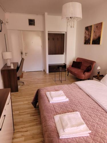 a bedroom with a bed with two towels on it at Sinaia Belleview in Sinaia