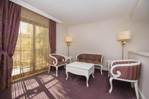 a room with two chairs and a table and a window at Han Deluxe Hotel in Oludeniz
