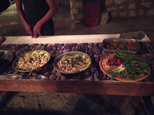 a table with four plates of food on it at Deep south Eco-lodge in Marsa Alam City