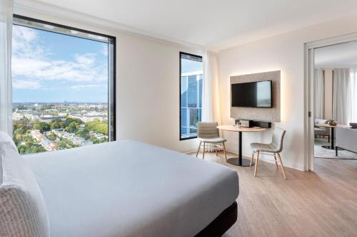 a hotel room with a bed and a large window at INNSiDE by Meliá Amsterdam in Amsterdam