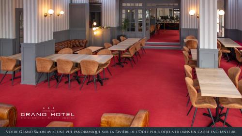 a row of tables and chairs in a room with red carpet at Grand Hôtel Bénodet Abbatiale Riviera Bretonne in Bénodet