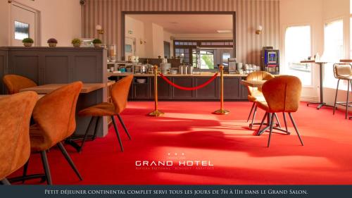 a room with orange chairs and a red carpet at Grand Hôtel Bénodet Abbatiale Riviera Bretonne in Bénodet