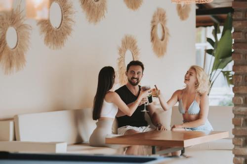 a group of three people sitting around a table at Han Deluxe Hotel in Oludeniz