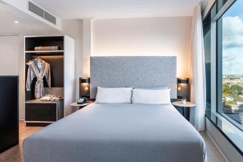 a bedroom with a large bed and a window at INNSiDE by Meliá Amsterdam in Amsterdam