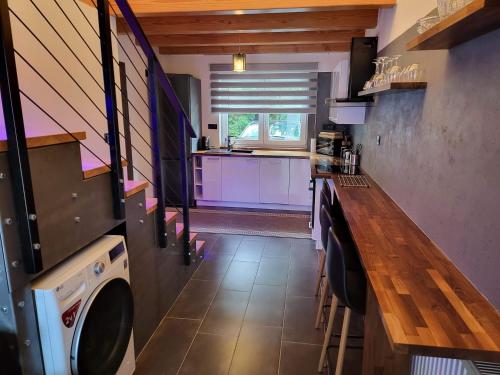 a kitchen with a washer and dryer in a house at Privát Kras in Holštejn