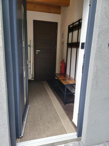 an open door to a room with a bench outside at Privát Kras in Holštejn