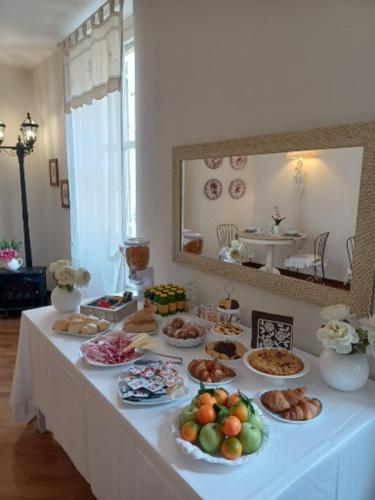 a table with many plates of food on it at B&B Casa del Teatro in Mantova