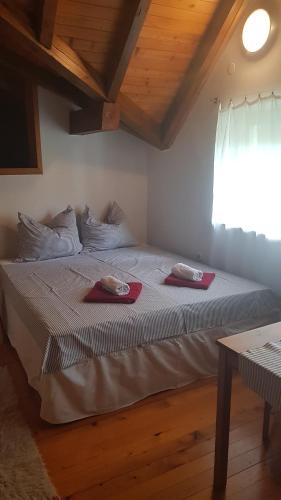 a bedroom with a bed with two towels on it at Pr'Simi in Golnik