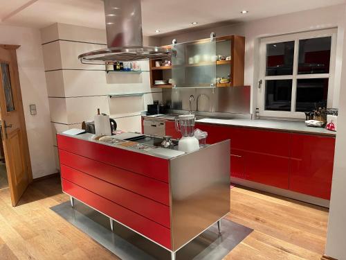 a kitchen with red cabinets and a red counter top at Villa Kitzbühel in Kirchberg in Tirol