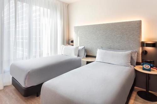 a hotel room with two beds and a window at INNSiDE by Meliá Amsterdam in Amsterdam