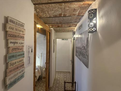 a hallway with a room with a toilet and posters on the wall at Apartamento CasaTrujillo in Trujillo