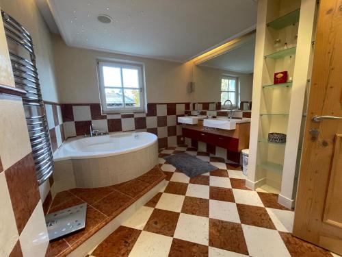 a large bathroom with a tub and a sink at Villa Kitzbühel in Kirchberg in Tirol