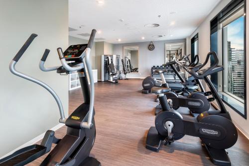 a row of treadmills in a fitness room with treadleys at INNSiDE by Meliá Amsterdam in Amsterdam