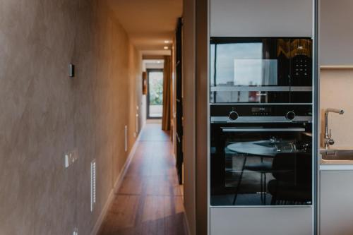 a kitchen with a black oven and a table at Petit Luxe Volta ÀTIC in Terrassa