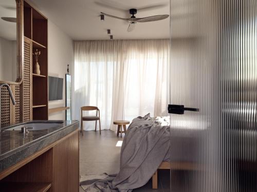 a hotel room with a bed and a window at Cielo villas - An Authentic Mediterranean Living in Zakynthos Town