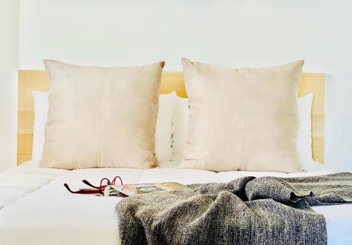 a white bed with pillows and a blanket on it at Canaryislandshost I Marquesa in Famara