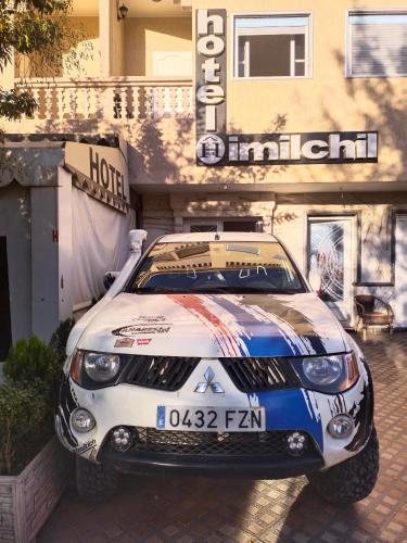 a race car parked in front of a hotel at Hôtel Imilchil in Midelt