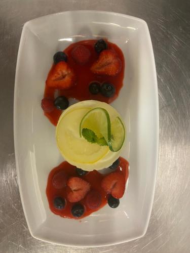 a plate of food with fruit and a melon on it at Hotel Pilgrimhaus in Soest