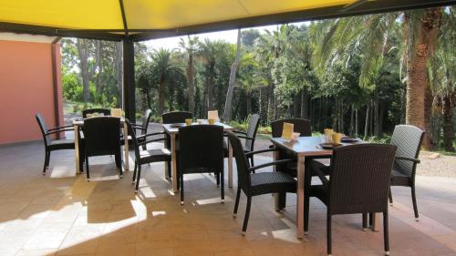 a restaurant with tables and chairs and a large window at B&B Capo Pero in Rio Marina