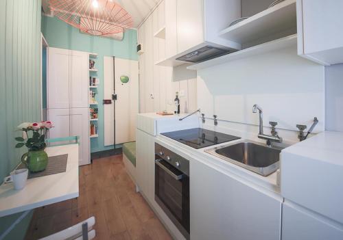 a kitchen with white counters and a sink and a sink at Apartments Florence - Pinzochere White in Florence