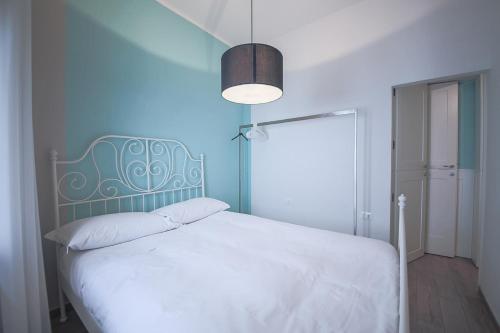 フィレンツェにあるApartments Florence - Pinzochere Whiteのベッドルーム1室(白いベッド1台、青い壁付)
