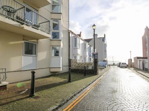 an empty street with buildings and a street light at 1 St Marys Court in Tenby